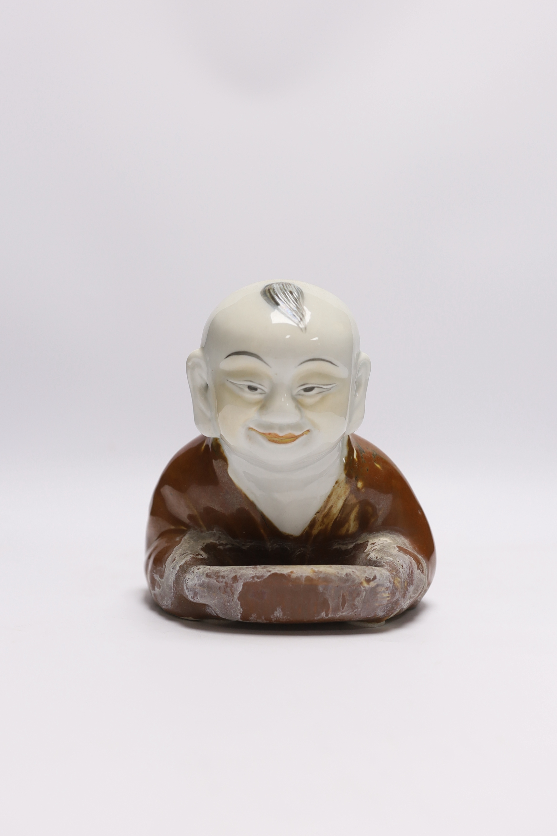 A Chinese porcelain ‘boy’ headrest, 29cm long